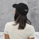 Black; Torn distressed dad hat with embroidered "Outsider" graphic of tent, tree, and moon